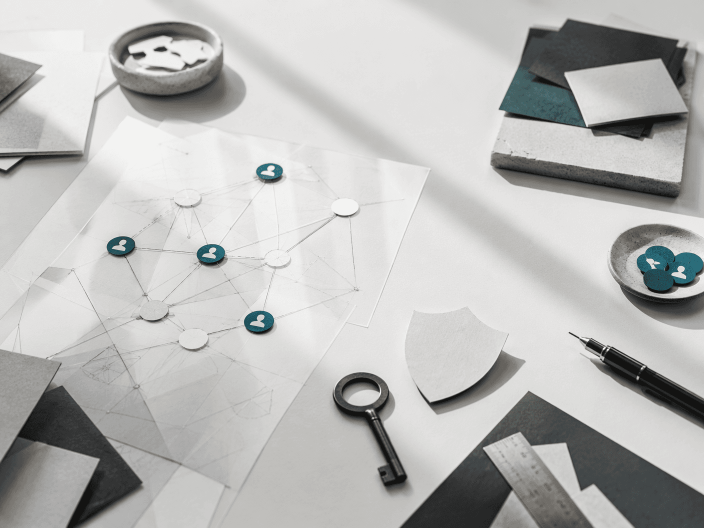 Paper identity network, key, and shield on a study desk
